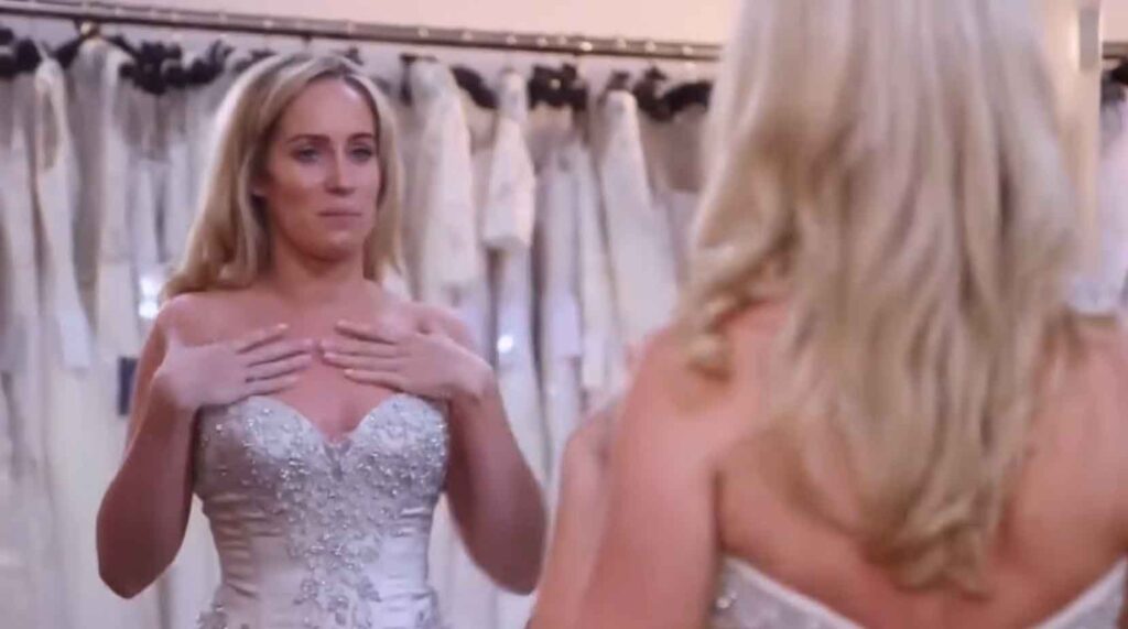 Bride expressing body insecurities about her arms in a strapless wedding dress.