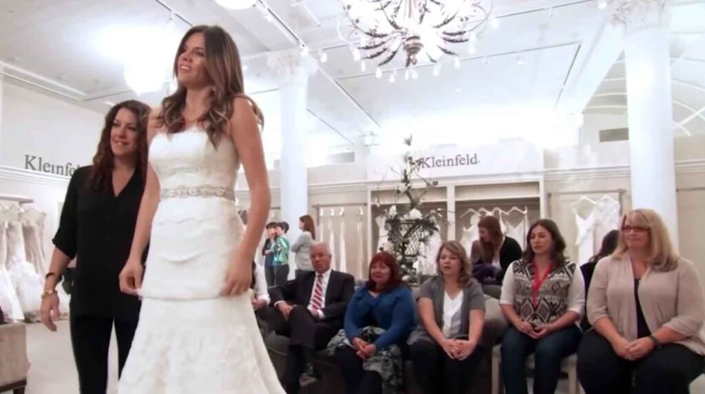 Bride Rachel smiling brightly in her tiered lace Rivini wedding dress