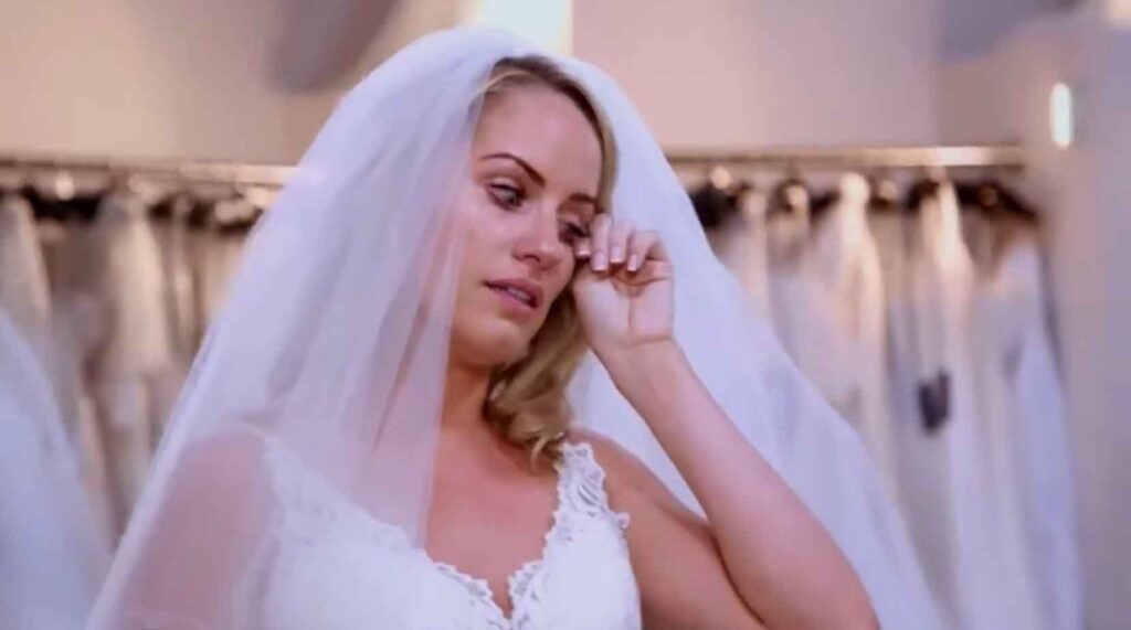Bride crying happy tears revealing her final wedding dress for St. Pauls Cathedral.