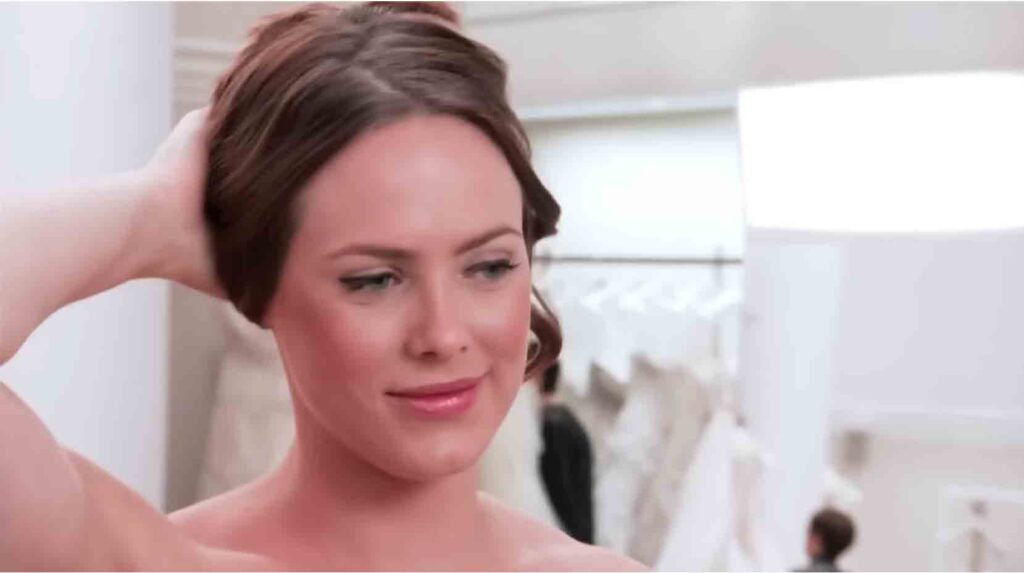 Bride Kara finding a middle ground in a sexy, form-fitting blush pink wedding dress.