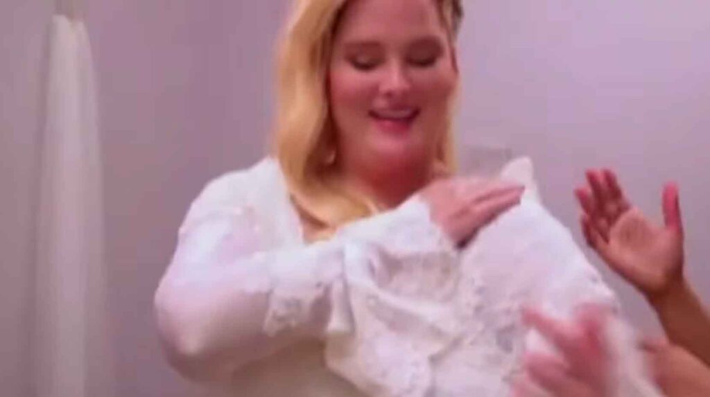 Close up of an ill-fitting vintage wedding dress struggling to zip up on a plus-size bride.