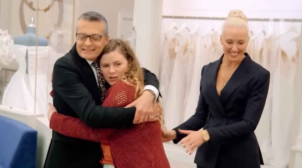 Tomboy bride smiling and feeling validated after finally trying on a bridal pantsuit