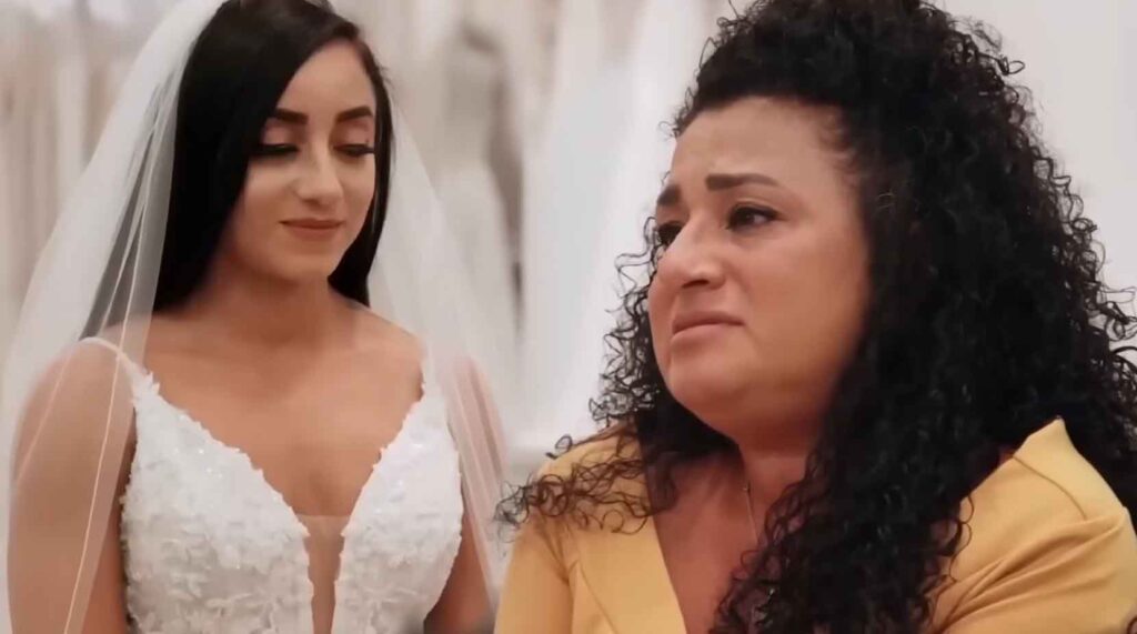 Mother of the bride crying after seeing her daughter wearing a bridal veil