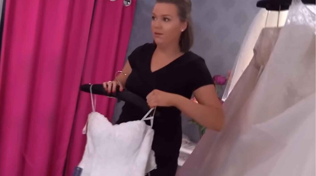 Bridal consultant pulling a banned fishtail mermaid wedding dress for the bride