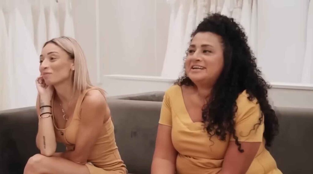 Picky mother of the bride criticizing a sparkly designer wedding dress