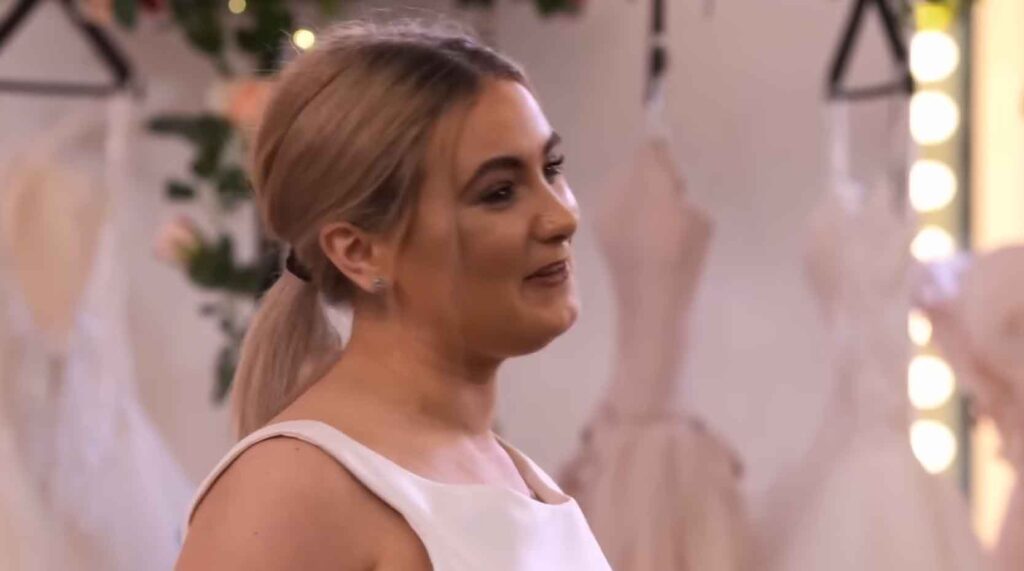 Smiling bride crying happy tears after a trauma-informed stylist custom-built her perfect wedding dress to restore her confidence.