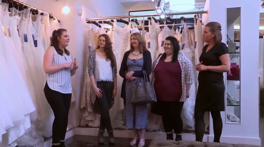 Wedding planner bride Claire reading her strict dress rules to the bridal consultants